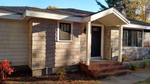 New overhang, front door, windows and cedar shingle siding.